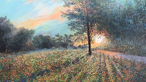 A colorful painting made up of dots depicting a field at sunset with trees in the background and one tall tree in toward the center.