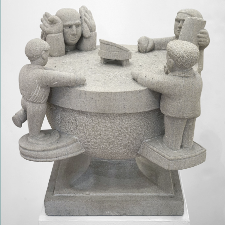 A round half-circle with a flat top and a square base. Around the circumference are four figures, each standing on a ledge that comes off the rounded semicircle. Two figures have their arms resting flat on the top. One has its hands up at the side of its face. The fourth figure is holding up a piece of paper with the text “YTTE” on it, honoring artist Achilles G. Rizzoli. YTTE, the name of his imaginary world, stands for “Yield to Total Elation.”