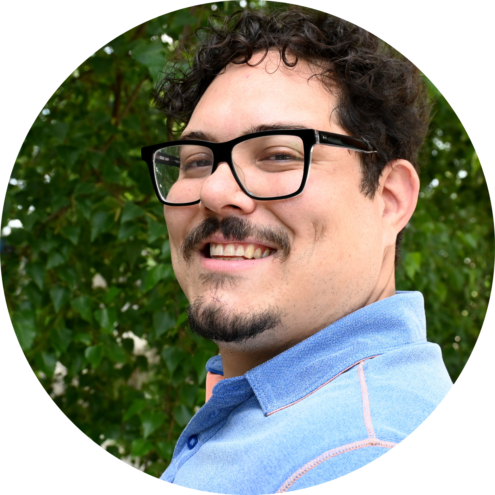 2 (1) a headshot of Mehdi Raoufi a male with dark curly hair a moustache and goatee wearing dark rimmed glasses and smiling