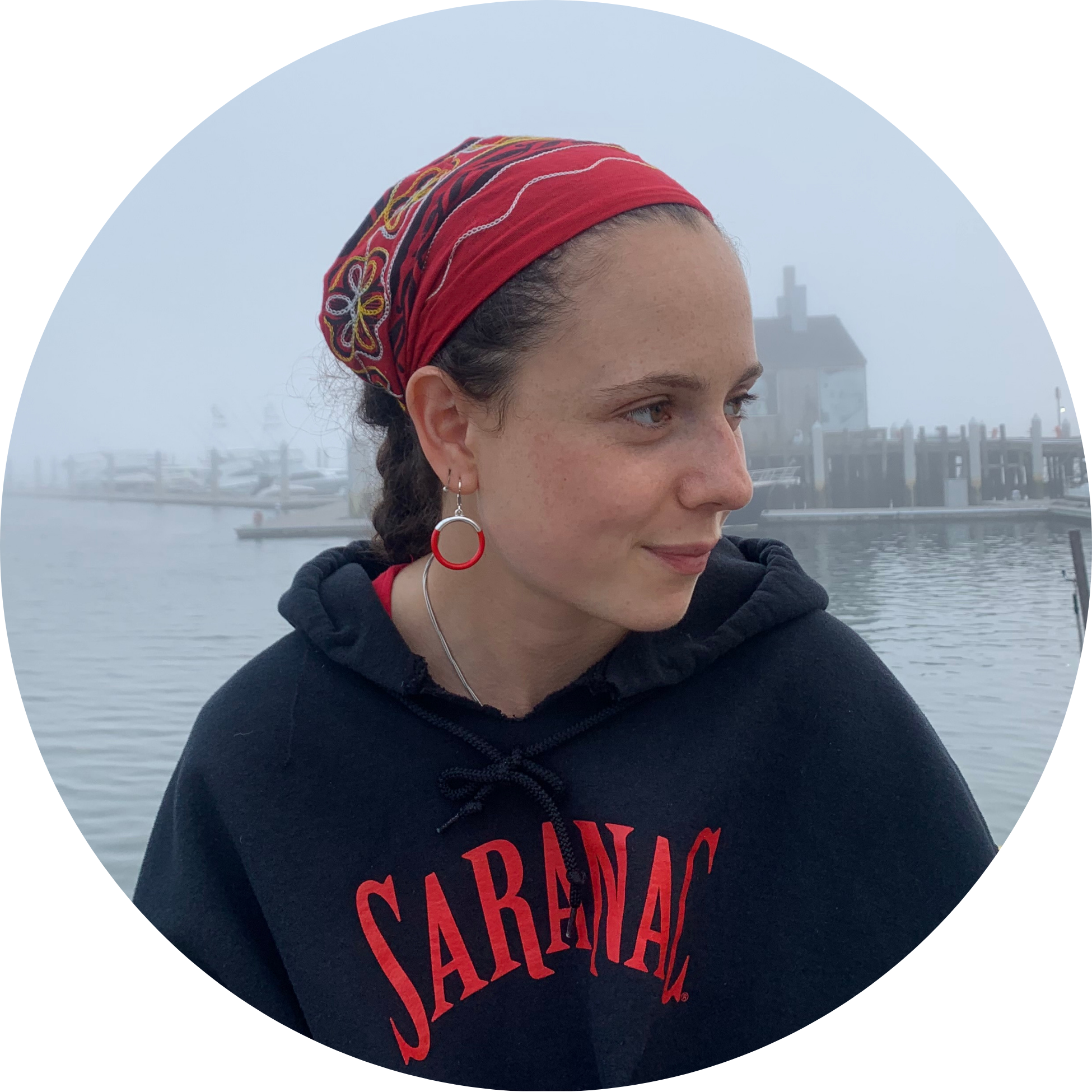 3 (1) a photo of Sadye Bobbette a white woman with brown hair pulled back under a read bandana on profile with a soft smile