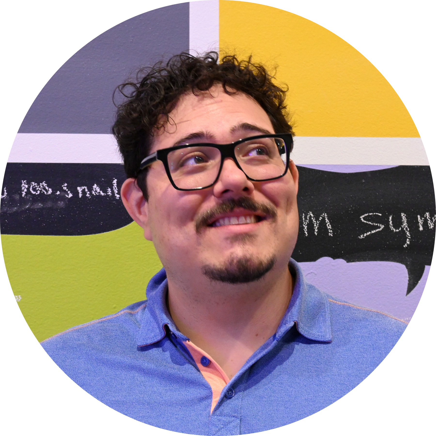 3 a head shot of Mehdi Raoufi, a man with curly brown hair, a mustache and goatee wearing black rim glasses and smiling looking away from the camera